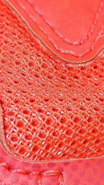 A close-up shot showcasing the intricate texture of a shoe upper made from Piñatex (pineapple leaf fiber), highlighting the sustainable alternative to traditional leather.