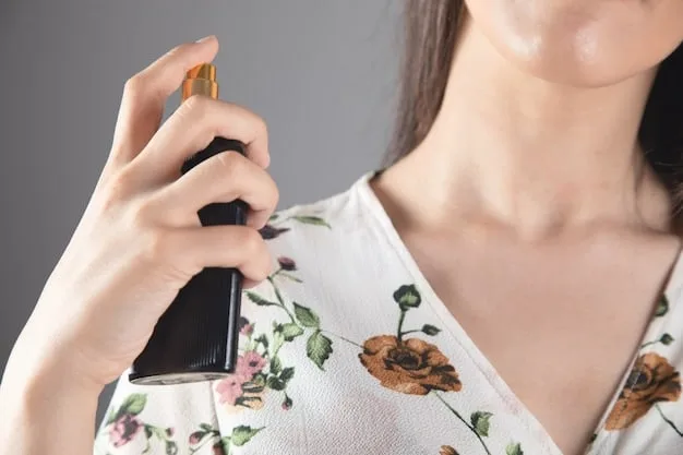 Close-up of a woman's wrist as she's spraying perfume from a very elegant perfume bottle. The focus is on the mist of the perfume and the texture of her skin.