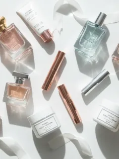 Collection of perfume bottles and beauty products for enhanced scent longevity