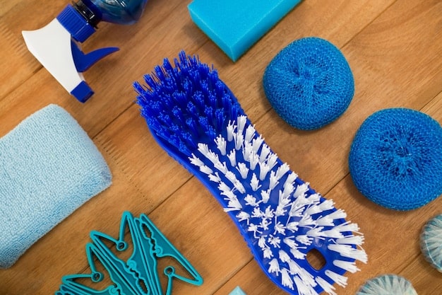 A close-up shot of various cleaning tools and materials, including a soft-bristled brush, microfiber cloth, sneaker cleaning solution, a bowl of warm water, and a suede eraser, all arranged neatly on a wooden surface.