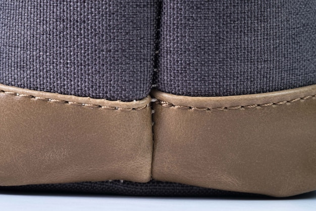A detailed close-up photo showing the difference in stitching quality between an authentic Nike sneaker and a counterfeit one. The real sneaker has tight, even, and precise stitching, while the fake has loose, uneven, and messy stitching with frayed ends.