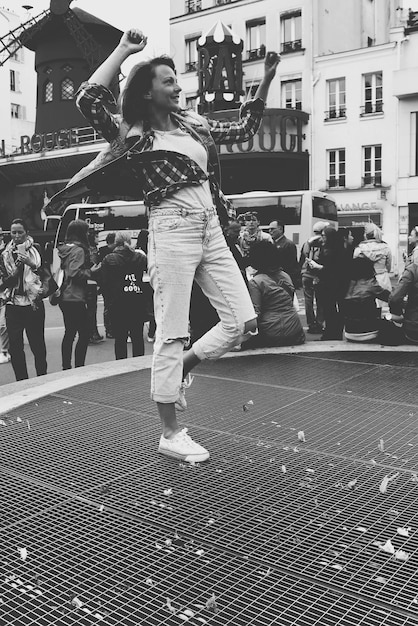 A black and white photograph of a breakdancing crew in Munich, Germany, in the 1980s, wearing Adidas sneakers and tracksuits. The image showcases the influence of American hip-hop culture on German youth.