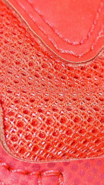 A close-up shot showcasing the intricate texture of a shoe upper made from Piñatex (pineapple leaf fiber), highlighting the sustainable alternative to traditional leather.