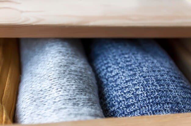 A close-up view of various types of breathable socks made of cotton, wool, and synthetic blends, neatly folded and arranged in a drawer. The focus is on the texture and material of the socks.