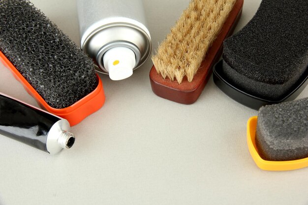 A variety of shoe deodorizing products displayed on a shelf in a store. The products include sprays, powders, and inserts.