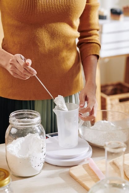 A person preparing a DIY concoction of baking soda and essential oils in a small bowl, with shoes in the background.