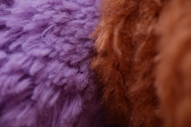 A close-up shot of different fabric textures used for layering, including merino wool, fleece, and a waterproof outer shell. The fabrics are arranged in a visually appealing way to showcase the different properties.