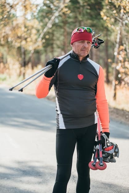 A German biathlete wearing Nike AeroAdapt gear during a competition in the Alps. The athlete is shown transitioning from a high-exertion skiing phase to a focused shooting phase, highlighting the fabric's ability to regulate temperature and provide comfort in varying conditions. The snowy mountain backdrop emphasizes the gear's performance in cold weather.