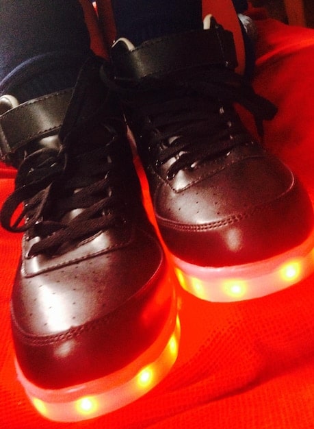 A close-up shot of a Nike basketball shoe showcasing the Zoom Air cushioning system. The design highlights the visible air pockets and the responsive nature of the technology. The shoe is placed on a basketball court with a German flag detail in the background.