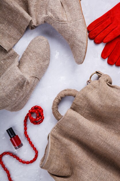 A close-up shot of various SHEIN workwear pieces laid out on a table, including a navy blazer, a white button-down shirt, a grey pencil skirt, and a pair of black pumps. The focus is on the quality of the fabrics and the attention to detail in the stitching and design.