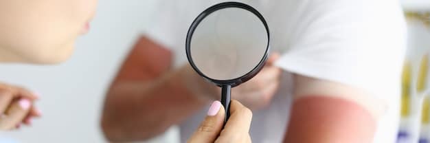 A dermatologist examining a patient's skin on their arm, where a red, patchy rash is visible due to a perfume allergy. The dermatologist is using a magnifying glass for closer inspection.