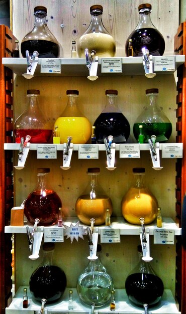 A German cosmetics store shelf filled with various perfume bottles. The focus is on the product labels, highlighting recognizable brands and clear ingredient lists. The background is slightly blurred, emphasizing the wide selection of perfumes available to consumers in Germany.