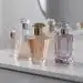 Elegant perfume bottles arranged for scent layering inspiration